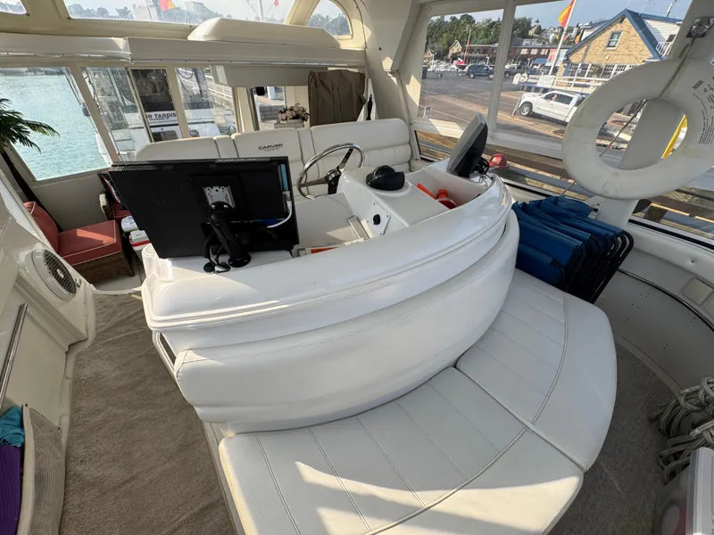 Slide: The Image of Interior of 2000 Carver 504 Cockpit Motor Yacht with white seating and navigation equipment. - 22
