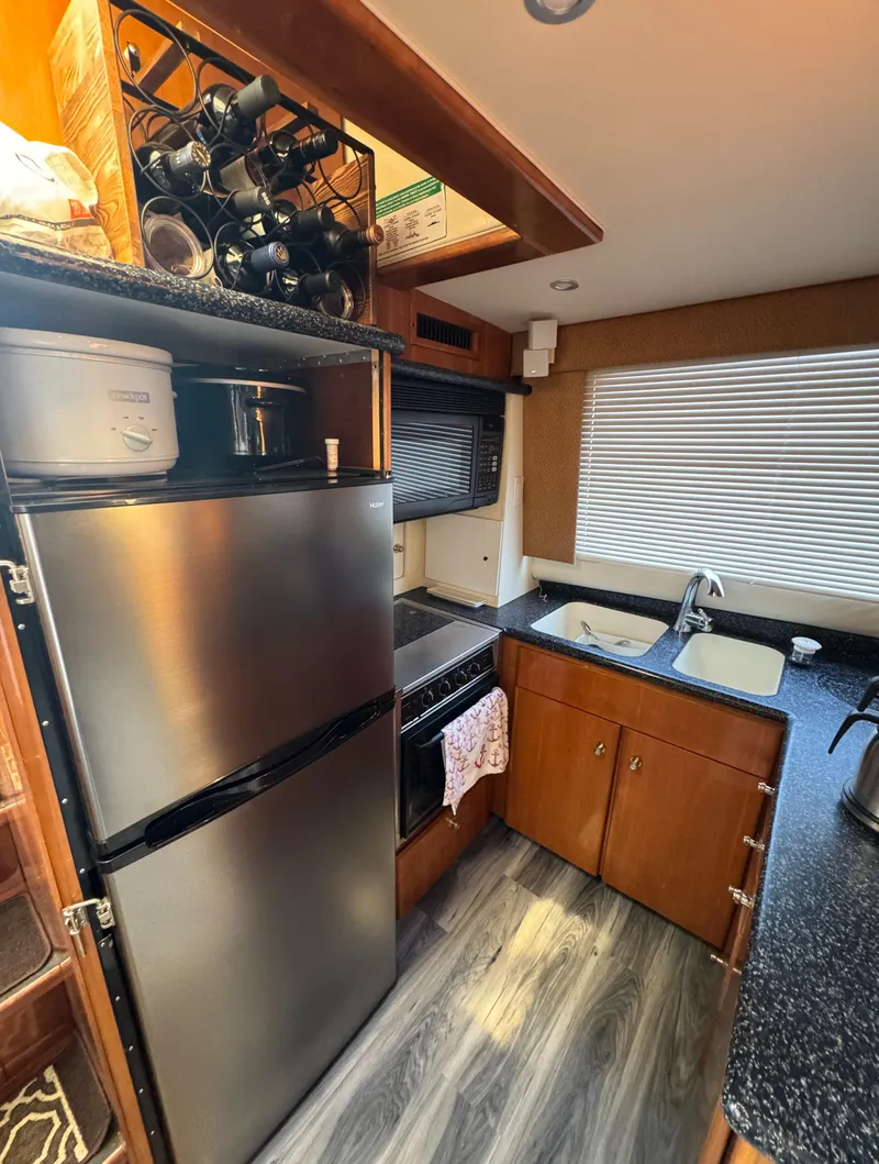 Slide: The Image of Modern kitchen in 2000 Carver 504 Cockpit Motor Yacht with stainless steel appliances. - 26