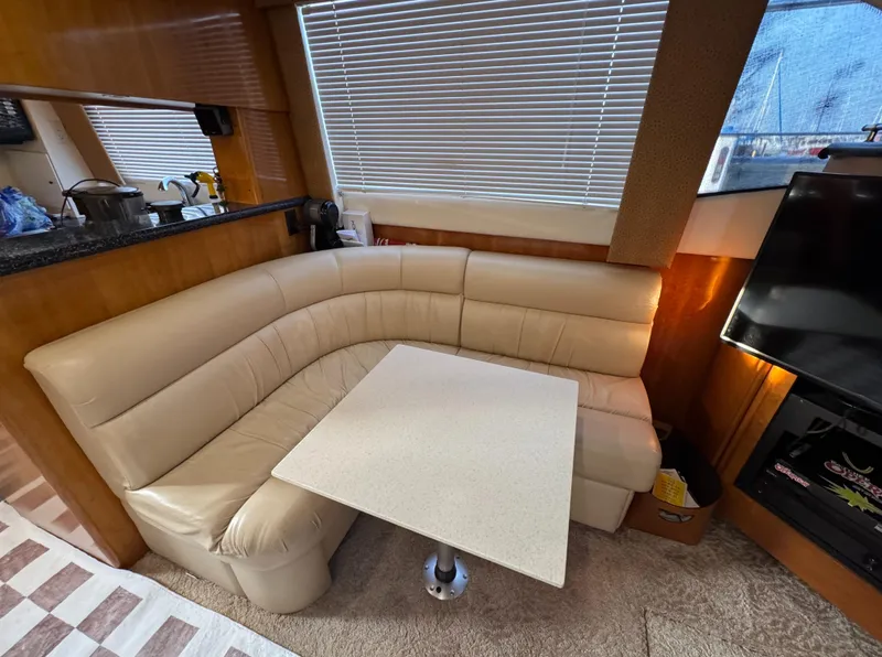 Slide: The Image of Interior of 2000 Carver 504 Cockpit Motor Yacht with beige leather seating and table. - 30
