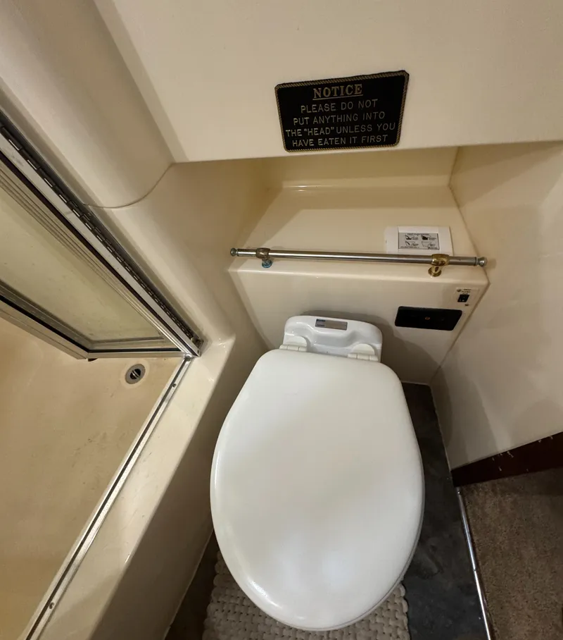 Slide: The Image of Toilet in 2000 Carver 504 Cockpit Motor Yacht bathroom with humorous notice sign. - 35