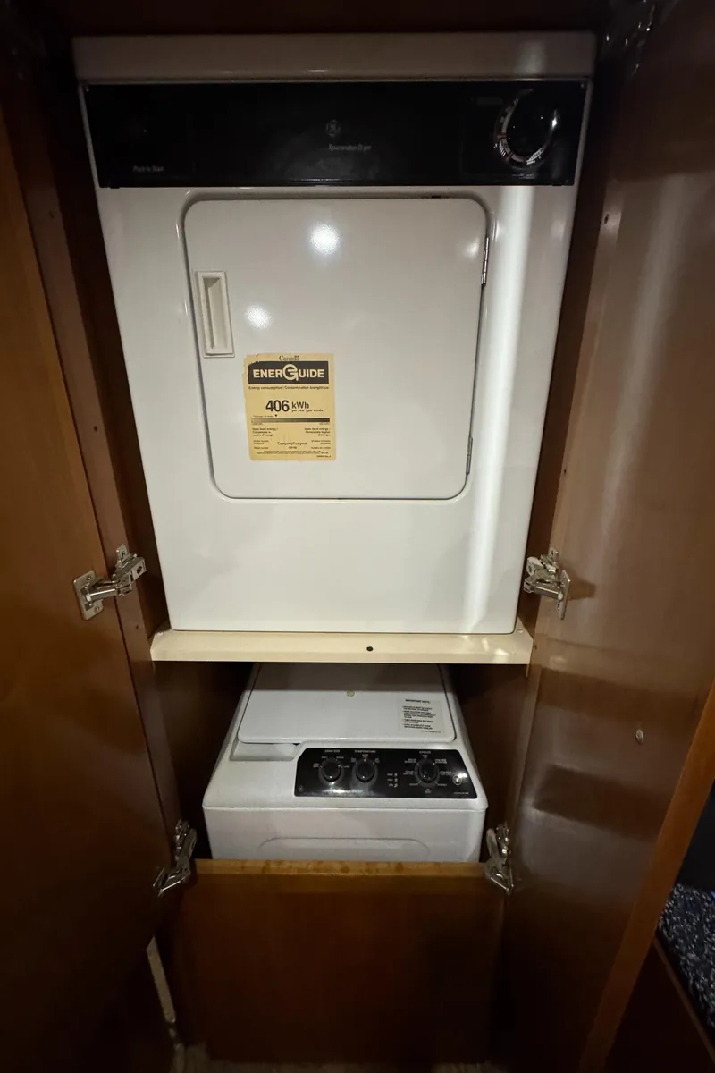 Slide: The Image of Laundry appliances inside a 2000 Carver 504 Cockpit Motor Yacht cabinet. - 36