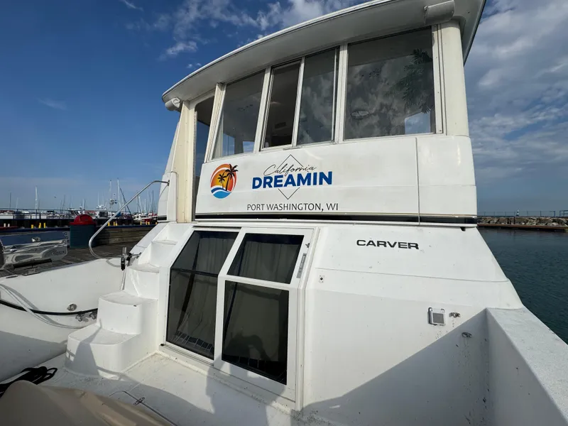 Slide: The Image of Carver 504 Cockpit Motor Yacht 2000 docked, featuring "Dreamin" signage, Port Washington, WI. - 4