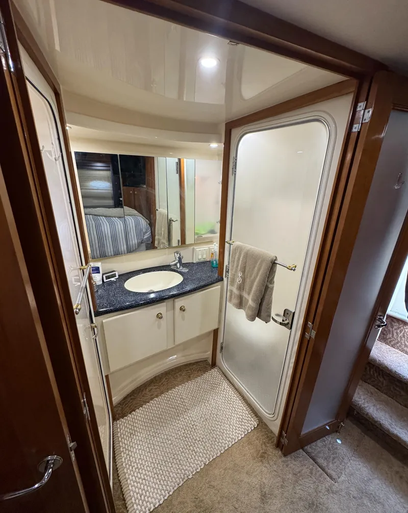 Slide: The Image of 2000 Carver 504 Cockpit Motor Yacht bathroom with sink, mirror, and shower. - 46