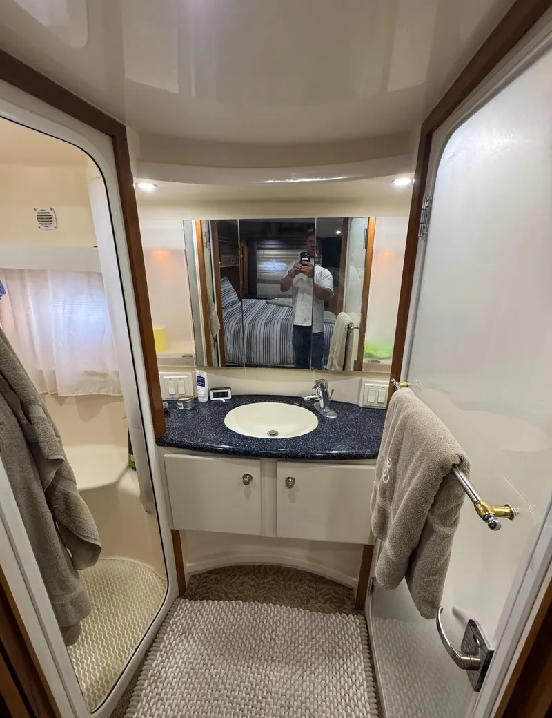 Slide: The Image of Bathroom interior of 2000 Carver 504 Cockpit Motor Yacht with sink and mirror. - 47