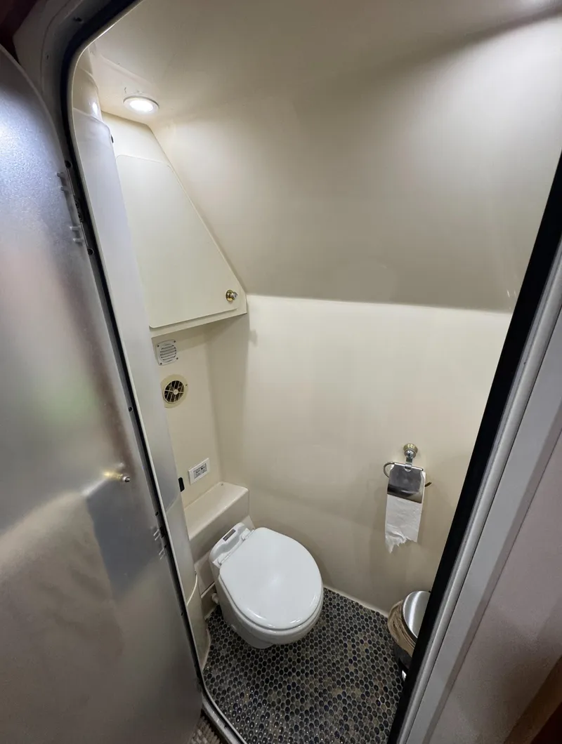 Slide: The Image of Compact bathroom in 2000 Carver 504 Cockpit Motor Yacht with modern fixtures. - 48