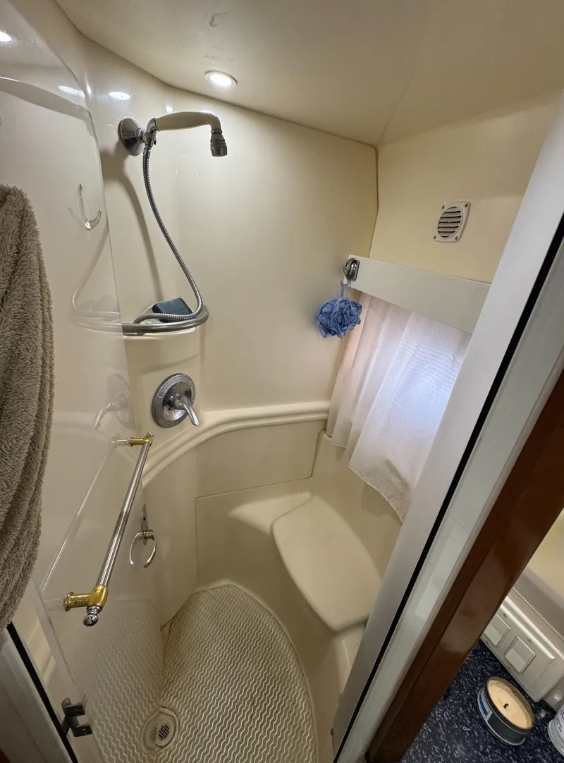 Slide: The Image of Compact bathroom in 2000 Carver 504 Cockpit Motor Yacht with shower and towel rack. - 49