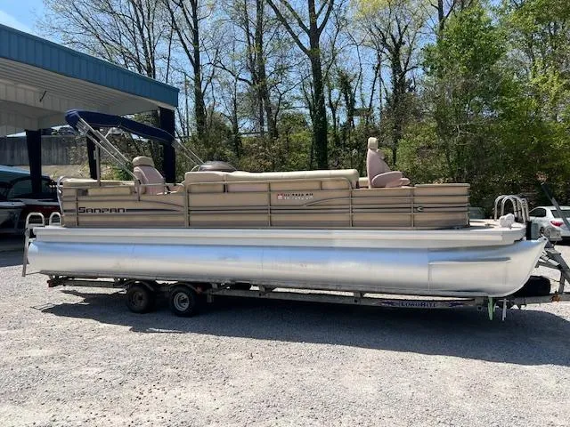The Image of 2008 Godfrey SANPAN 2500 DC pontoon boat on trailer, parked outdoors. - 0