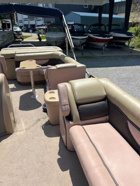 Slide: The Image of 2008 Godfrey SANPAN 2500 DC pontoon boat with beige seating and table, docked outdoors. - 17