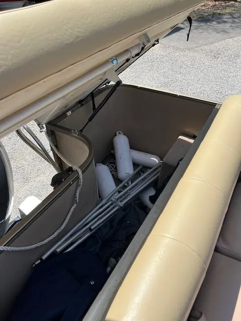 Slide: The Image of Open storage compartment in a 2008 Godfrey SANPAN 2500 DC boat with fenders and poles. - 7