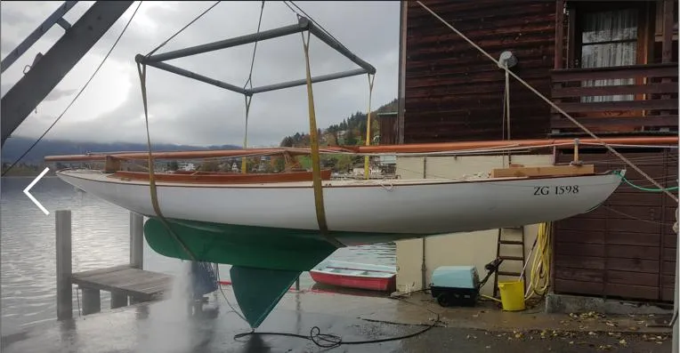 Slide: The Image of Herreshoff Watch Hill 15 sailboat from 1995 suspended near a lakeside dock. - 6