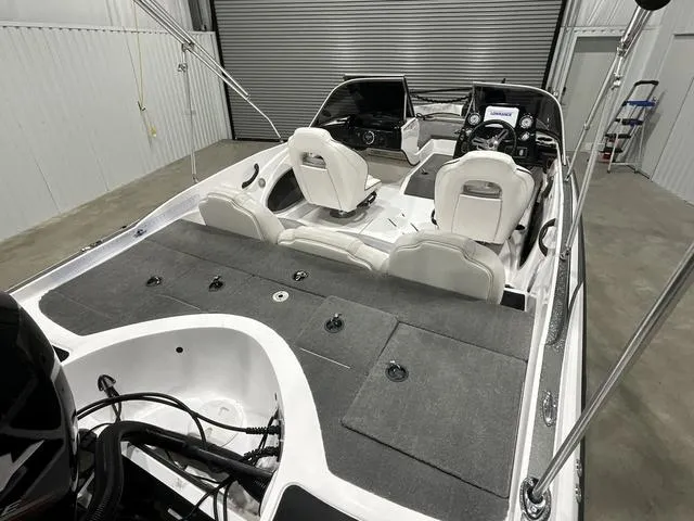 Slide: The Image of 2019 Nitro Z19 Sport boat interior with seating and dashboard in a garage setting. - 11