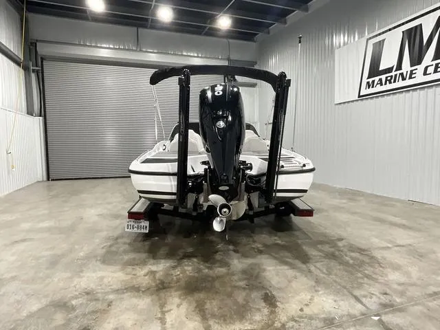 Slide: The Image of 2019 Nitro Z19 Sport boat in a showroom, rear view with motor and trailer. - 5