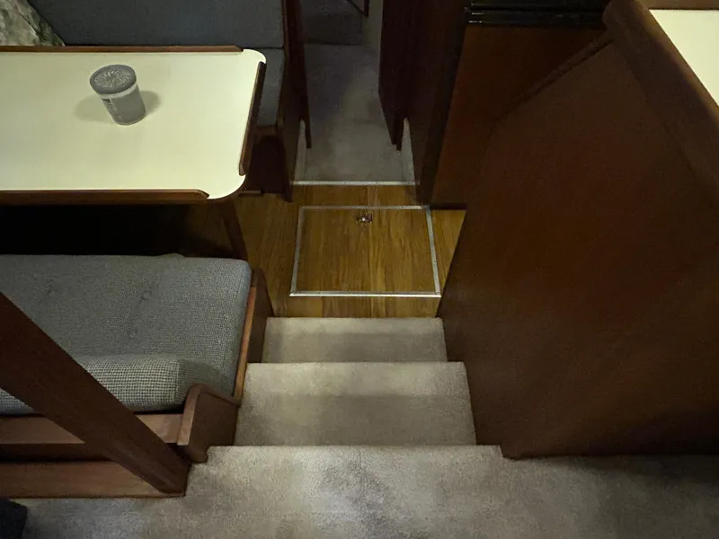 Slide: The Image of 1987 Chris-Craft 362 Catalina interior with stairs, table, and seating area. - 21