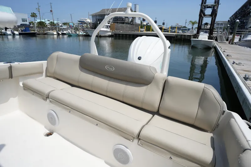 Slide: The Image of 2023 Key West 219 FS boat with beige seating, docked at a marina. - 15