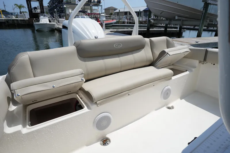 Slide: The Image of 2023 Key West 219 FS boat interior with beige seating and storage compartments. - 17
