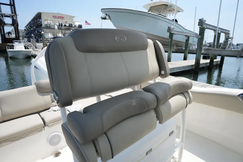 Slide: The Image of 2023 Key West 219 FS boat with comfortable seating at a marina. - 21