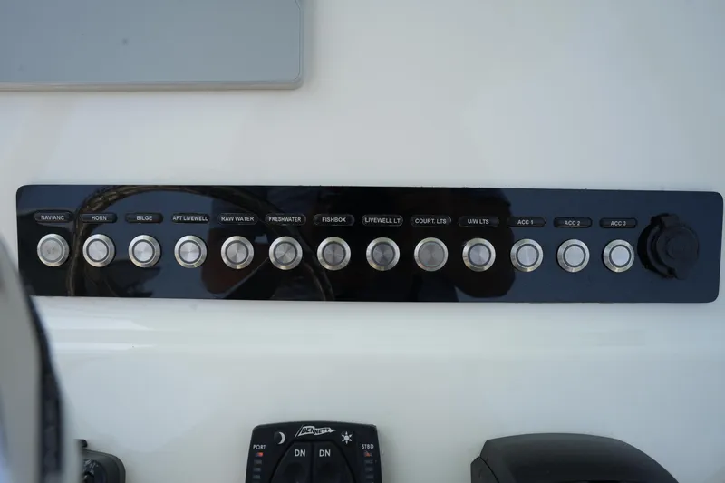 Slide: The Image of Control panel of 2023 Key West 219 FS boat with labeled switches. - 24