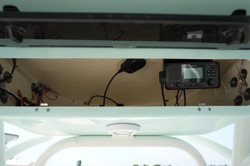 Slide: The Image of 2023 Key West 219 FS boat console with electronic equipment and wiring. - 29