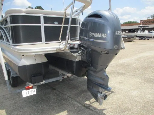 Slide: The Image of 2018 Bennington 22SLXP pontoon boat with Yamaha 150 outboard motor, parked on concrete. - 10