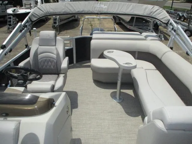 Slide: The Image of 2018 Bennington 22SLXP pontoon boat interior with plush seating and steering console. - 5