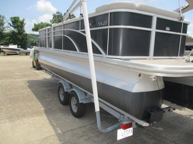 Slide: The Image of 2018 Bennington 22SLXP pontoon boat on a trailer, parked outdoors. - 9