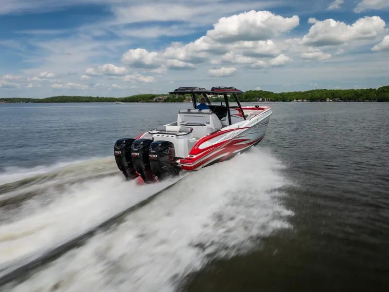 Slide: The Image of 2017 Sunsation 34 CCX speedboat cruising on a lake under a partly cloudy sky. - 10