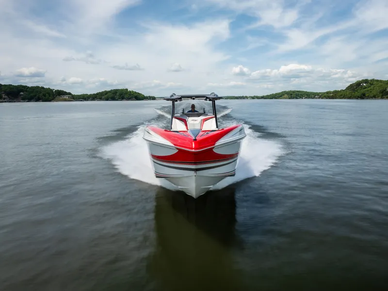 Slide: The Image of 2017 Sunsation 34 CCX speedboat cruising on a lake under a blue sky. - 14