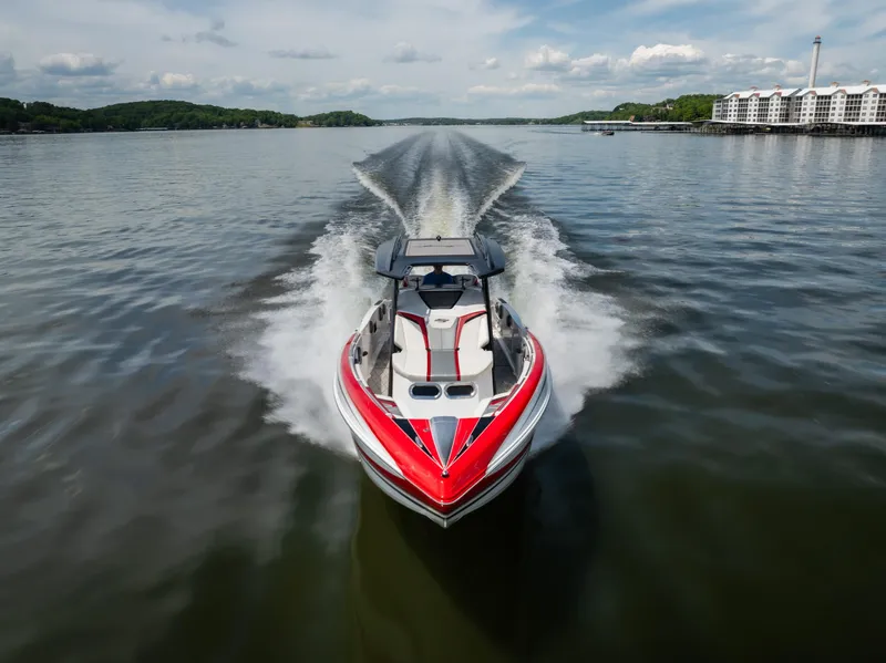 Slide: The Image of 2017 Sunsation 34 CCX speedboat cruising on a lake with scenic background. - 15