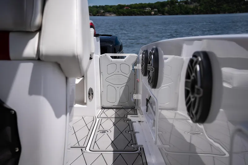 Slide: The Image of 2017 Sunsation 34 CCX boat interior with speakers, white seating, and lake view. - 16