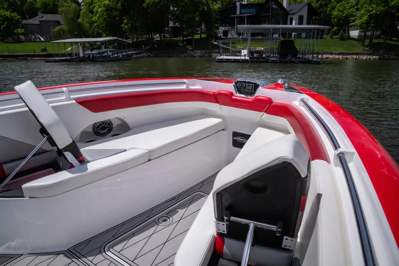 Slide: The Image of 2017 Sunsation 34 CCX boat interior with red and white seating, docked by a lake. - 25