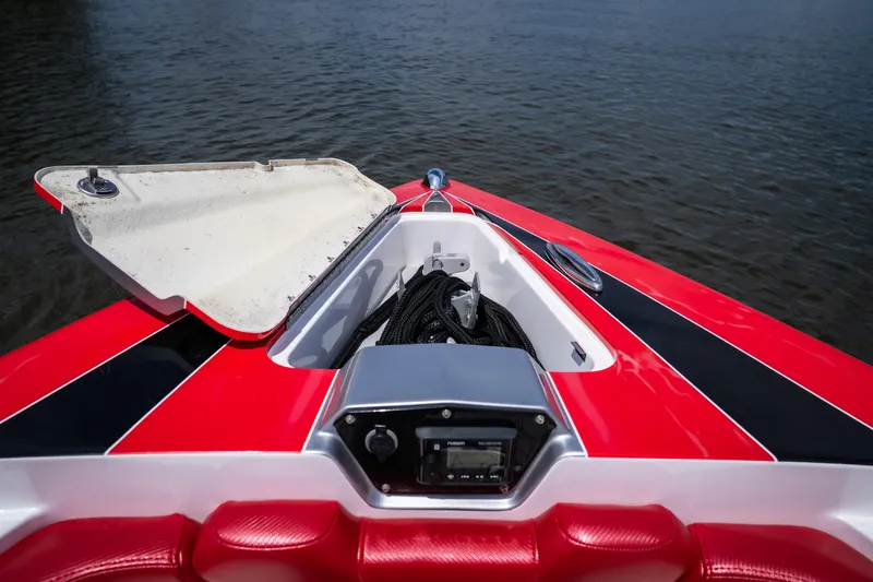Slide: The Image of 2017 Sunsation 34 CCX boat bow with open storage compartment on water. - 27
