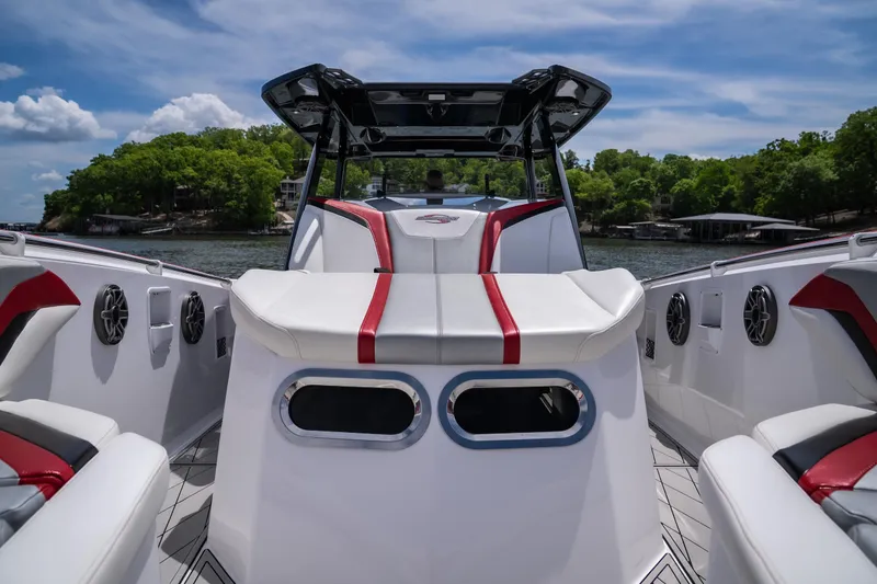 Slide: The Image of 2017 Sunsation 34 CCX boat interior with red accents, docked on a sunny day. - 28