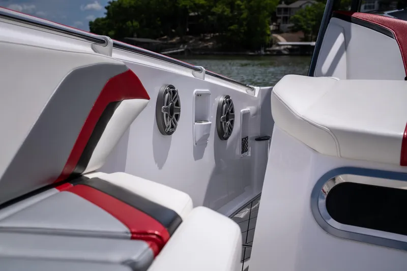 Slide: The Image of 2017 Sunsation 34 CCX boat interior with white and red seating, speakers, and lake view. - 29