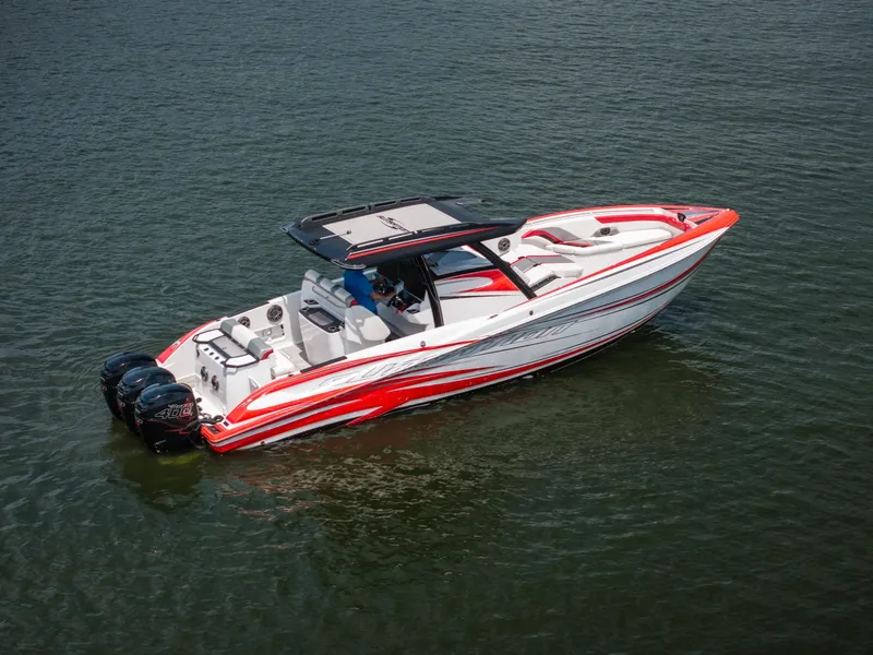 Slide: The Image of 2017 Sunsation 34 CCX boat with red and white design on calm water. - 3