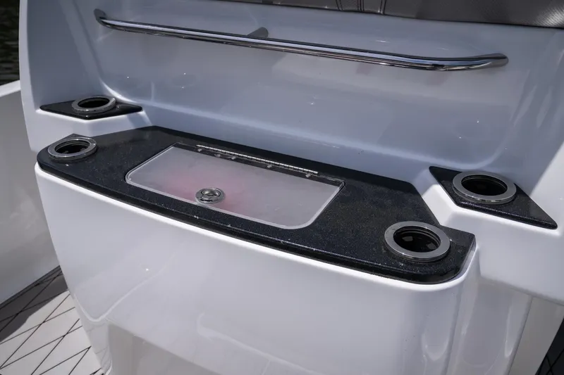 Slide: The Image of 2017 Sunsation 34 CCX boat console with cup holders and storage compartment. - 35