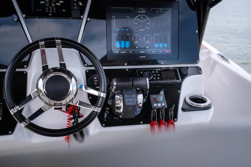 Slide: The Image of Steering console of 2017 Sunsation 34 CCX boat with modern controls and display. - 39