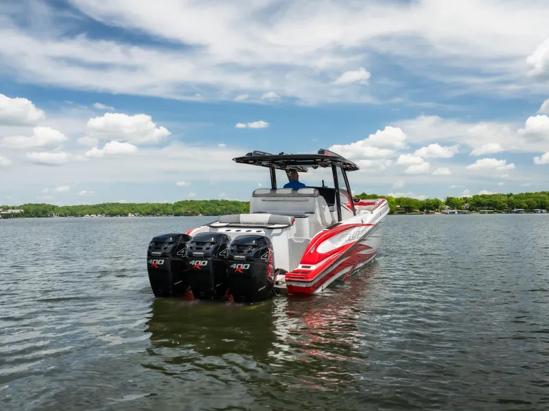 Slide: The Image of 2017 Sunsation 34 CCX boat with triple outboard engines on a calm lake. - 4
