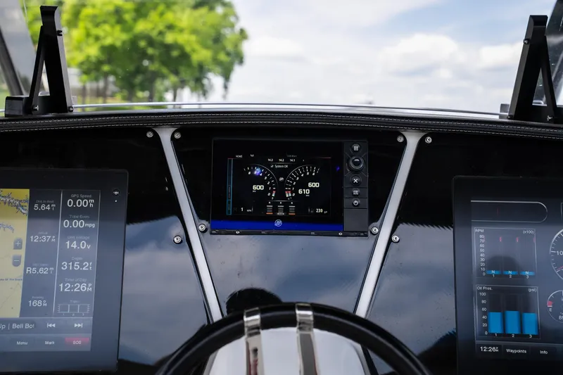 Slide: The Image of Dashboard of a 2017 Sunsation 34 CCX boat with digital displays and steering wheel. - 40