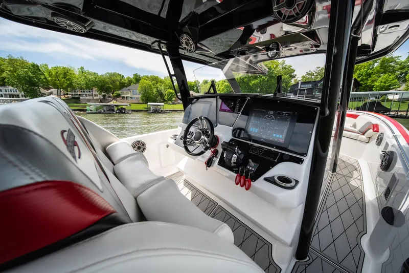 Slide: The Image of 2017 Sunsation 34 CCX boat interior with modern dashboard and luxurious seating on a sunny day. - 43