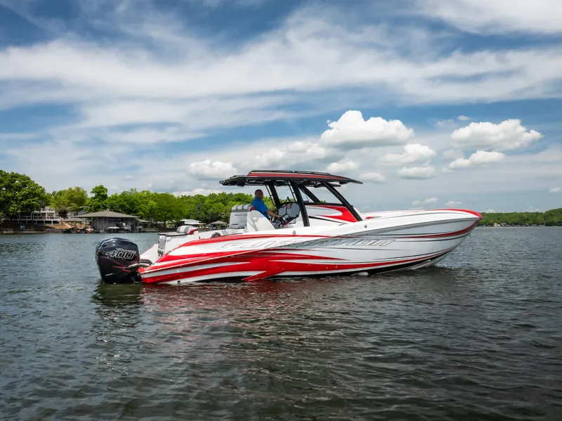 Slide: The Image of 2017 Sunsation 34 CCX boat on a lake, featuring sleek red and white design. - 5
