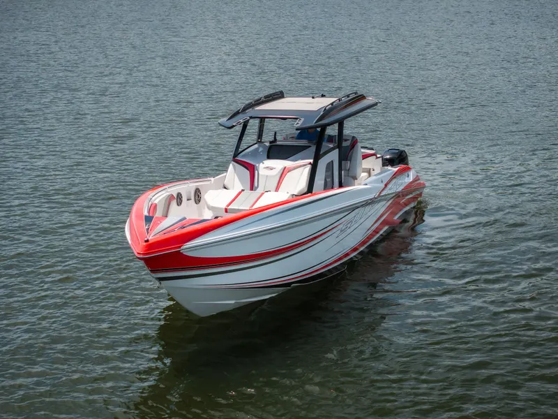 Slide: The Image of 2017 Sunsation 34 CCX boat with red and white design on calm water. - 7