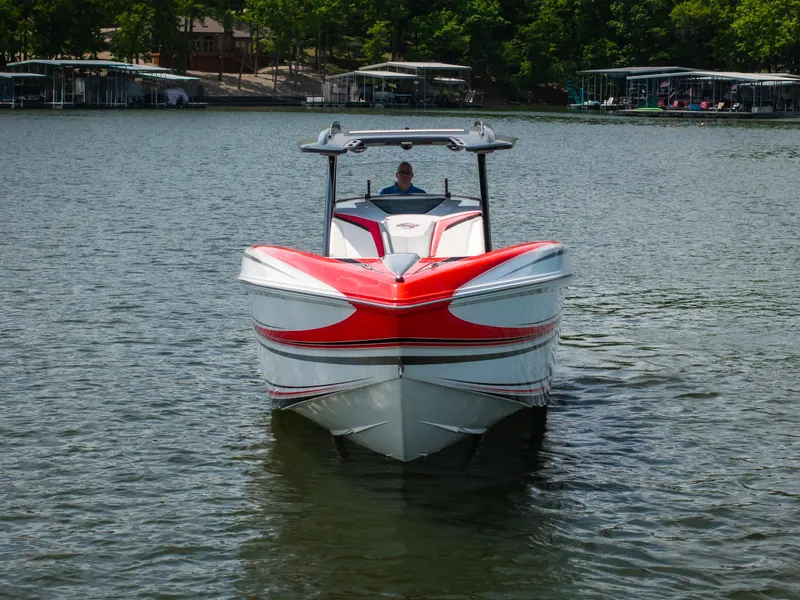 Slide: The Image of 2017 Sunsation 34 CCX boat on a lake, featuring a striking red and white design. - 8