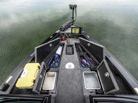 Slide: The Image of 2026 Lund 2075 Pro V Sport boat interior with open storage compartments and fishing gear. - 3