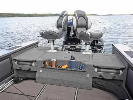 Slide: The Image of 2026 Lund 2075 Pro V Sport boat interior with dual seats and storage on a lake. - 5