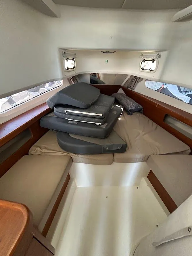 Slide: The Image of Nimbus T11 2022 boat interior with seating, table, and ocean view. - 12
