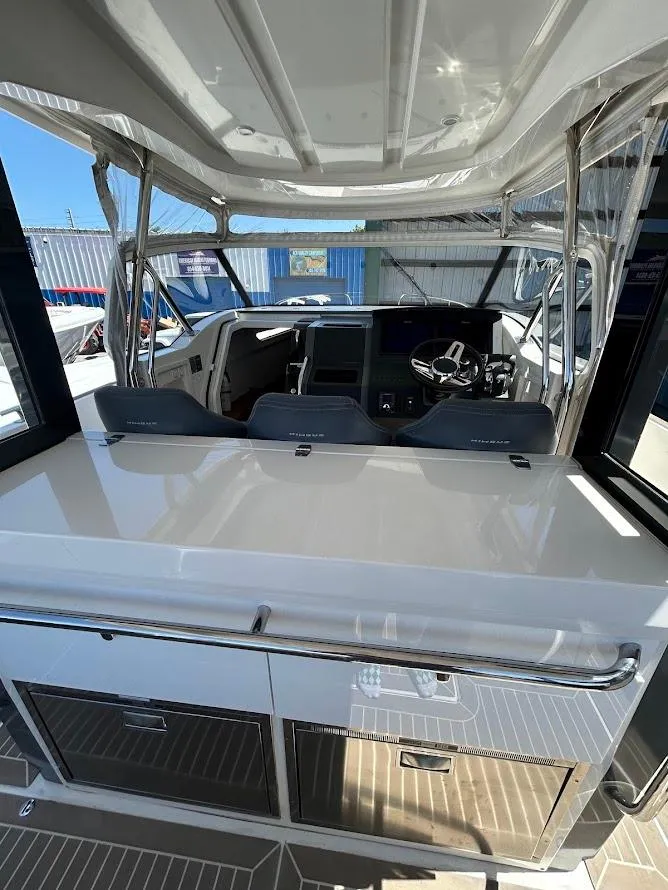 Slide: The Image of 2022 Nimbus T11 boat on water, featuring sleek design and spacious deck. - 5