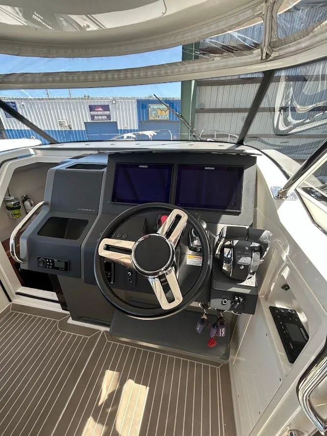 Slide: The Image of Interior view of 2022 Nimbus T11 boat cockpit with navigation screens and steering wheel. - 8