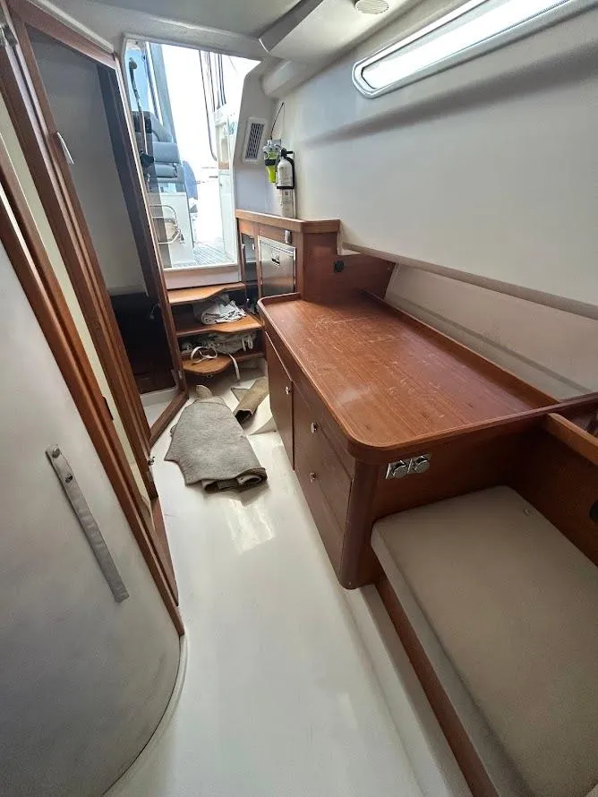 Slide: The Image of 2022 Nimbus T11 boat with dual Mercury engines on a sunny waterfront. - 13