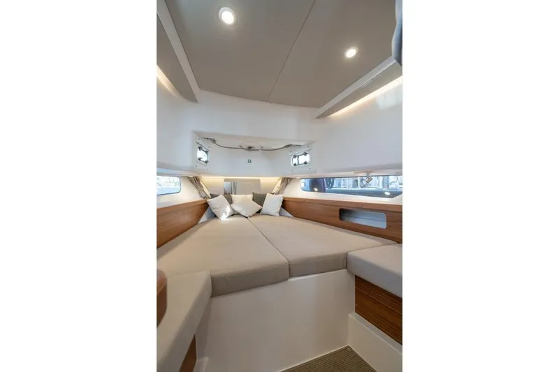Slide: The Image of Luxurious interior cabin of 2022 Nimbus T11 boat with cozy bedding and modern design. - 16