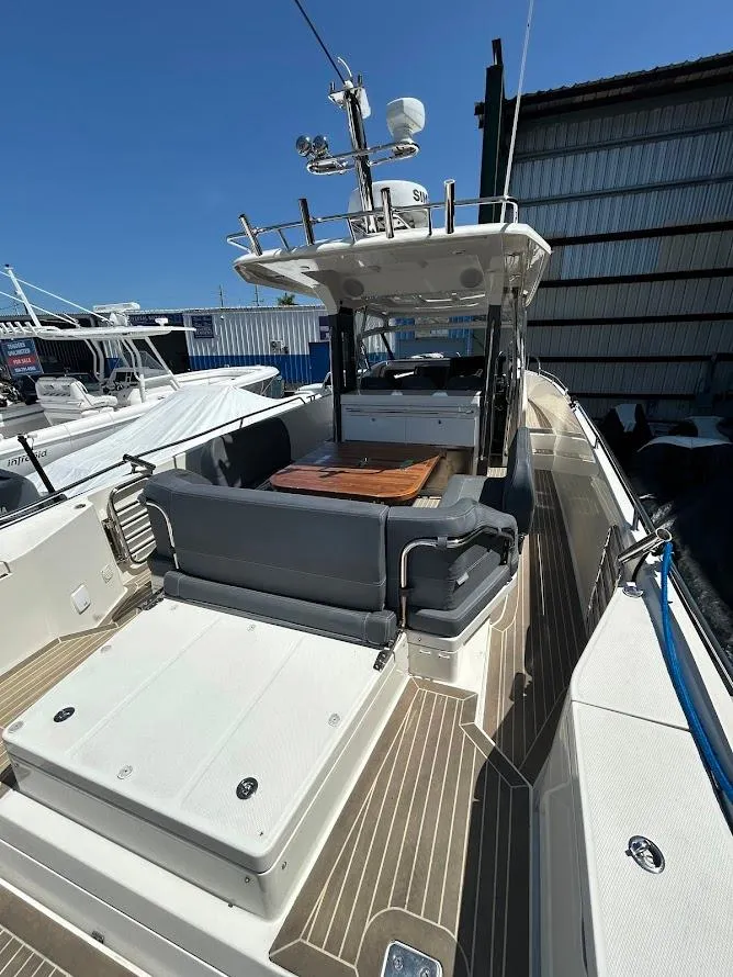 Slide: The Image of 2022 Nimbus T11 boat on display under clear blue sky. - 3